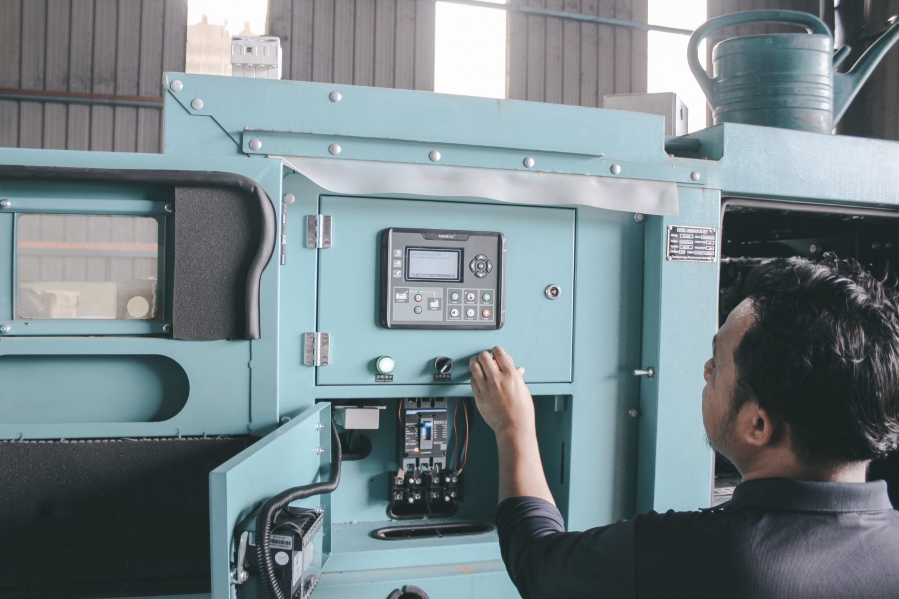 A Dyna technician starting a generator set from its control panel