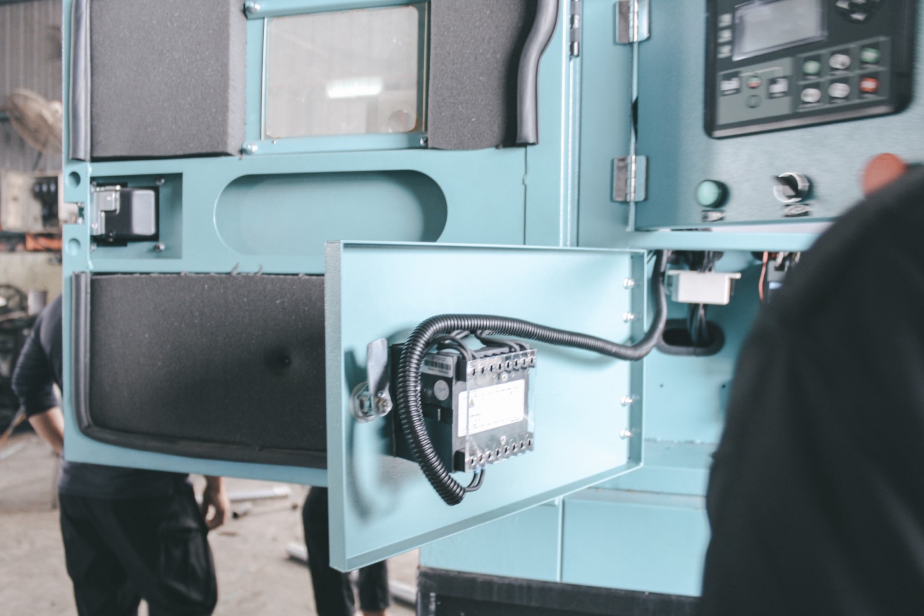 Open control cabinet on a Dyna generator set, showing its relay module and wiring